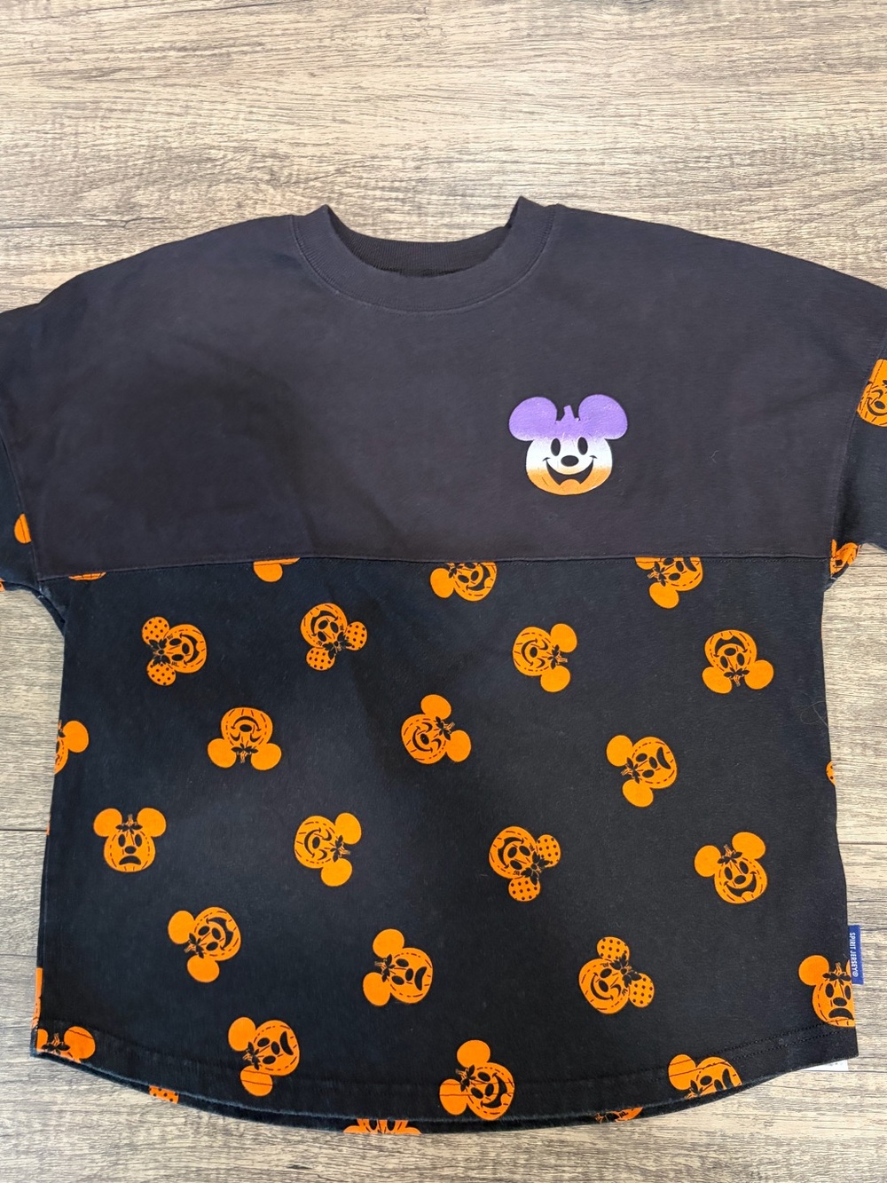 Disney Black Sweatshirt with Orange Mickey Pumpkin Print and Purple Accent.